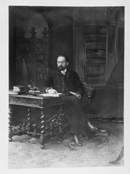 Emile Zola in his study